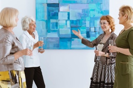 art collectors marveling at artwork