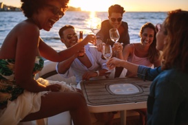 people on boat drinking wine